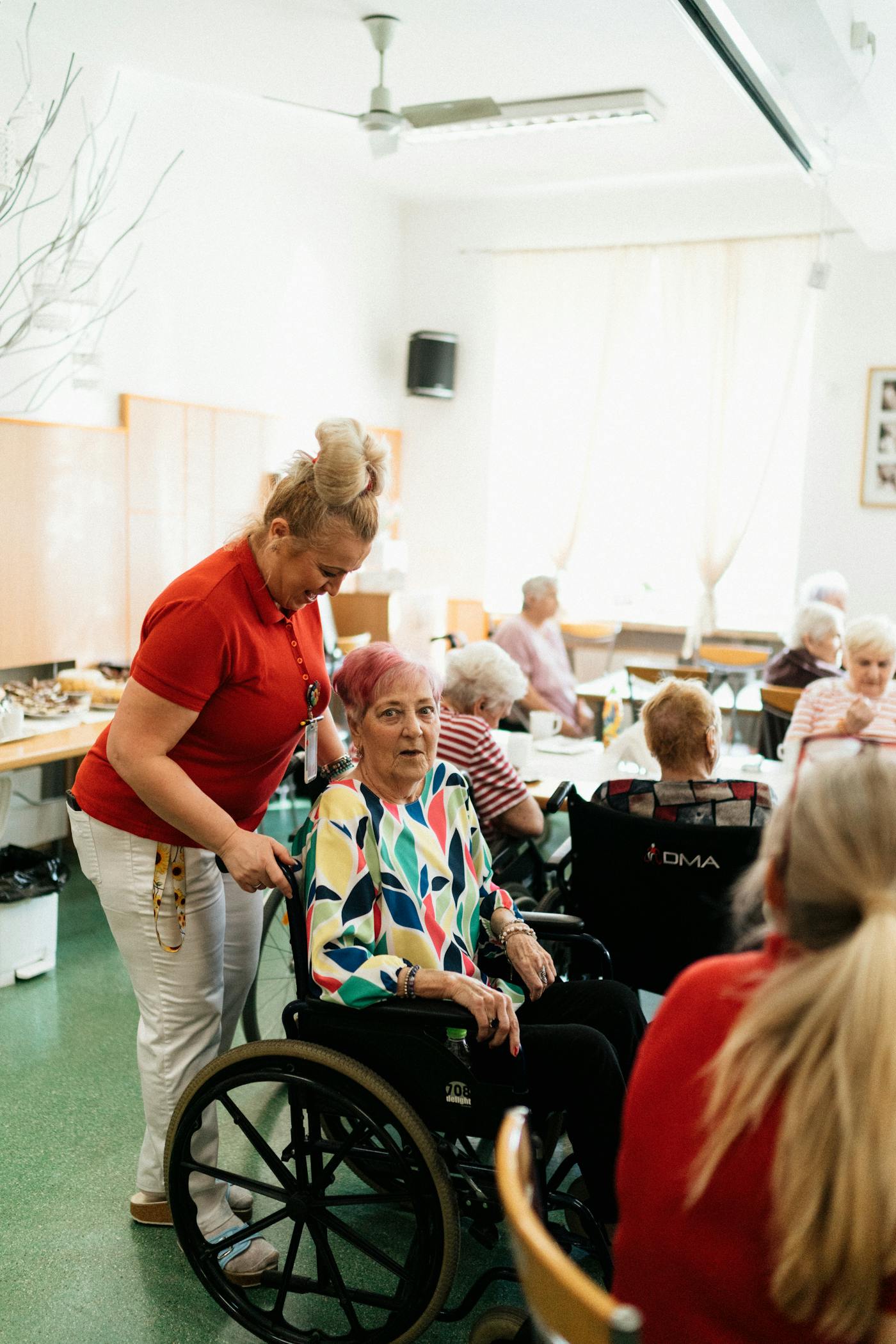 Carer supporting a wheelchair user in a community space